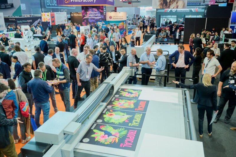 Attendees networking and exploring growth opportunities at FESPA events in Munich.