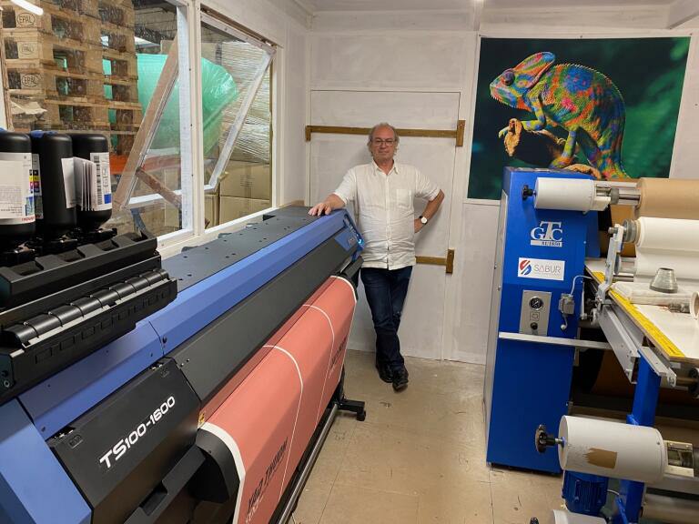 Stephen Davies, owner and MD of Southsea Deckchairs, standing next to the Mimaki TS100-160 dye-sublimation printer.
